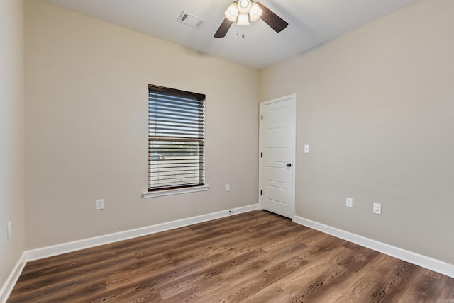 unfurnished room featuring dark hardwood / wood-style floors and ceiling fan