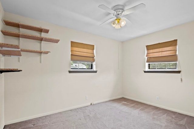 carpeted empty room with a healthy amount of sunlight and ceiling fan