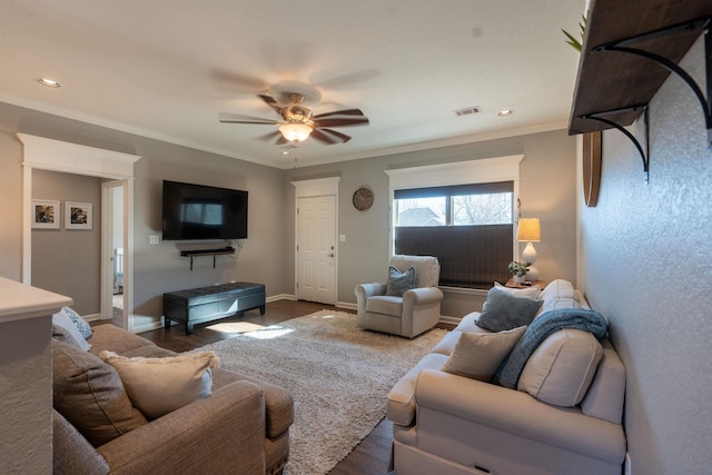 living room featuring crown molding, dark hardwood / wood-style floors, and ceiling fan