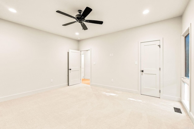 unfurnished bedroom featuring visible vents, light colored carpet, and recessed lighting