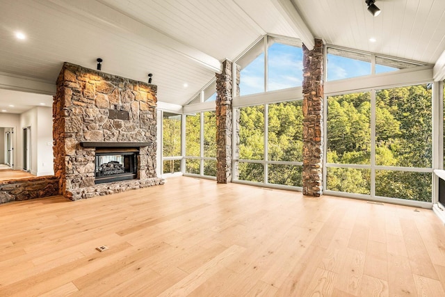 unfurnished sunroom featuring lofted ceiling, a fireplace, and wooden ceiling