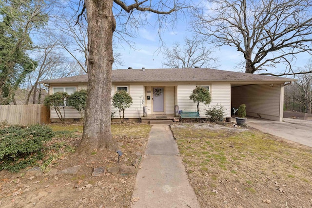 view of front of home featuring crawl space, fence, an attached carport, and concrete driveway