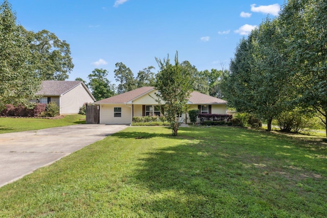 ranch-style house featuring concrete driveway and a front yard