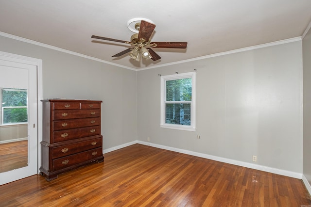 unfurnished bedroom with crown molding, baseboards, ceiling fan, and wood finished floors