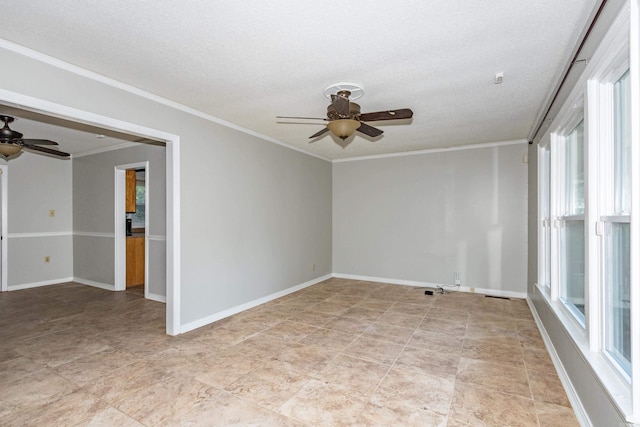 spare room with ornamental molding, ceiling fan, a textured ceiling, and baseboards