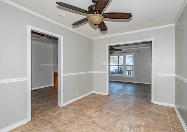 unfurnished room featuring a ceiling fan, crown molding, and baseboards