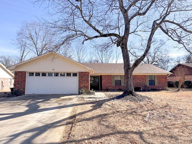 ranch-style house with a garage, concrete driveway, and brick siding