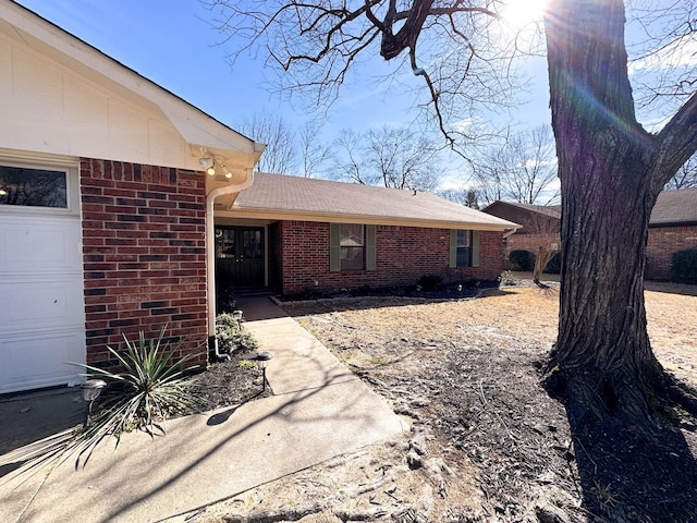 exterior space with brick siding and an attached garage