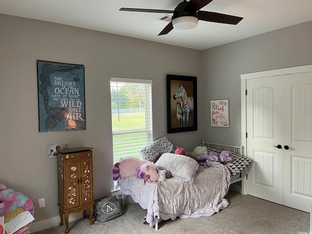 carpeted bedroom with a closet and ceiling fan