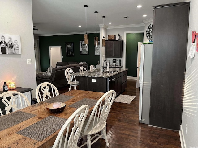 dining room with baseboards, visible vents, dark wood finished floors, ornamental molding, and recessed lighting