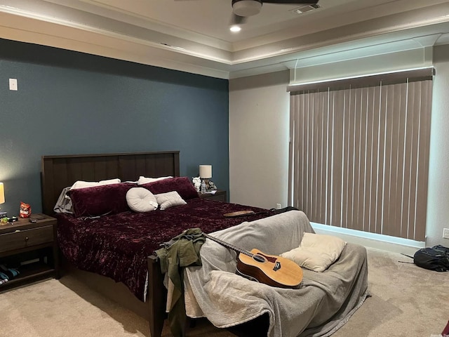 bedroom with a raised ceiling, light carpet, and visible vents