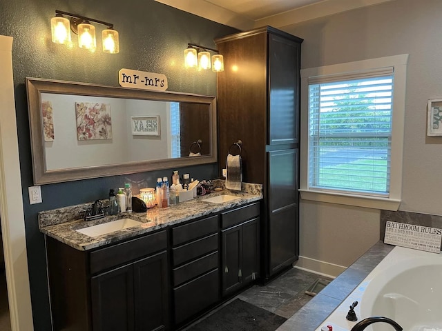 bathroom featuring a tub, a sink, baseboards, and double vanity