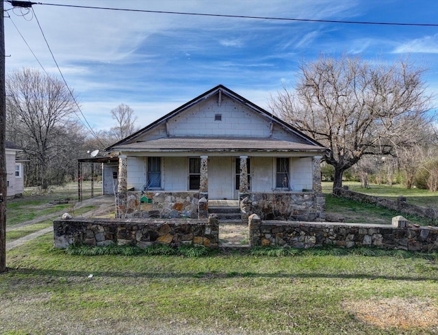 bungalow-style home with a porch and a front yard