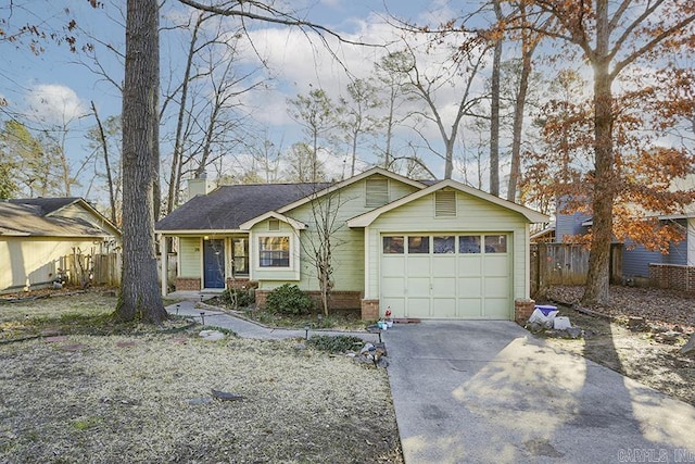 view of front of property featuring driveway, a garage, a chimney, and brick siding