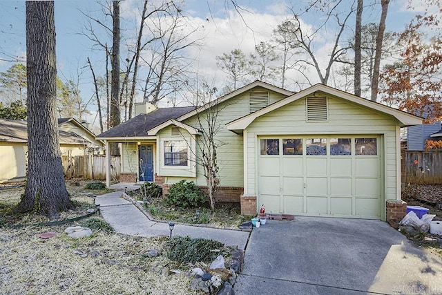 view of front of home with a garage, driveway, brick siding, and fence