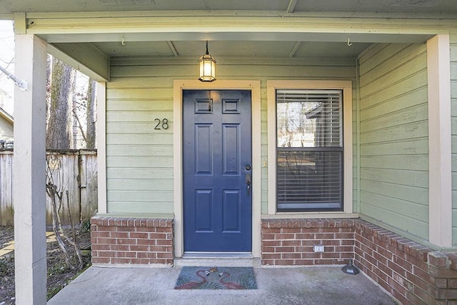 entrance to property featuring brick siding