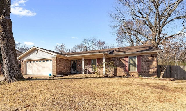 ranch-style house featuring a garage, fence, a front lawn, and brick siding