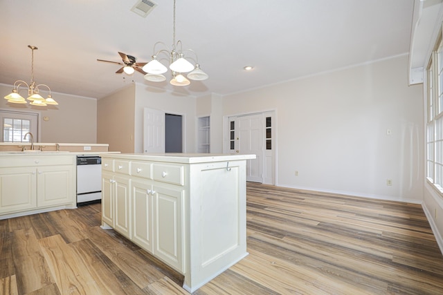 kitchen with a center island, visible vents, an inviting chandelier, a sink, and dishwasher