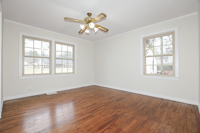 spare room with ornamental molding and dark wood-type flooring