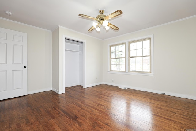 unfurnished bedroom featuring baseboards, crown molding, visible vents, and dark wood-type flooring