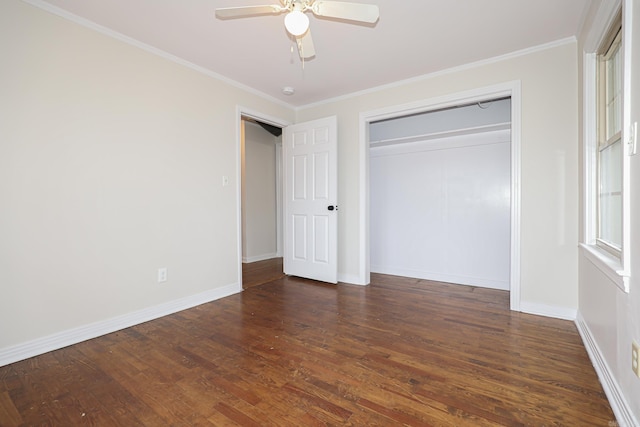 unfurnished bedroom with dark wood-style floors, crown molding, and baseboards