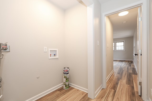 washroom featuring laundry area, hookup for a washing machine, wood finished floors, and baseboards