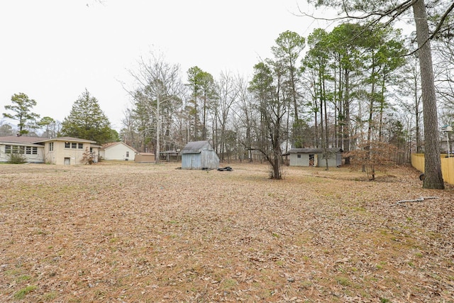 view of yard with a storage shed and an outbuilding