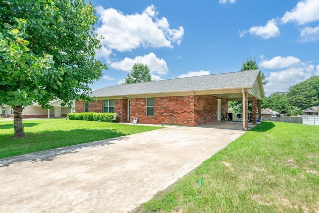 ranch-style home featuring an attached carport, brick siding, driveway, and a front lawn