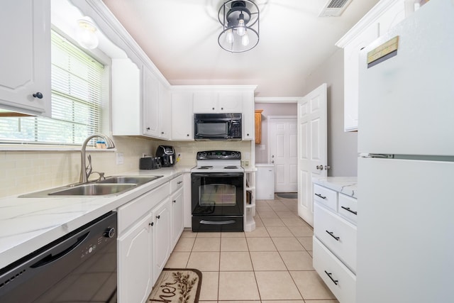 kitchen with visible vents, white cabinetry, a sink, light tile patterned flooring, and black appliances