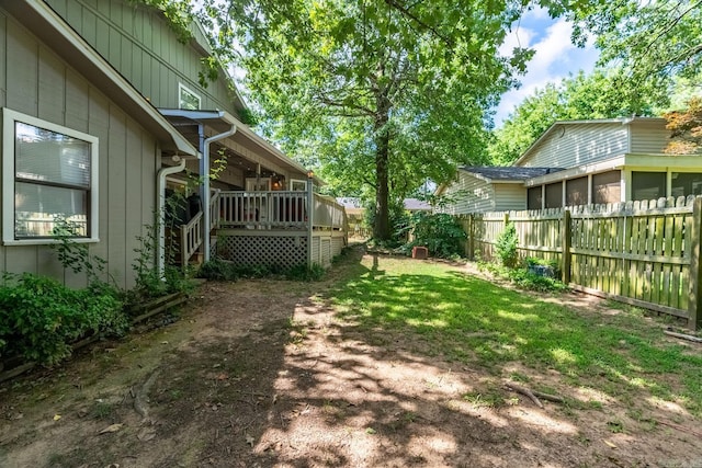 view of yard featuring a deck and fence