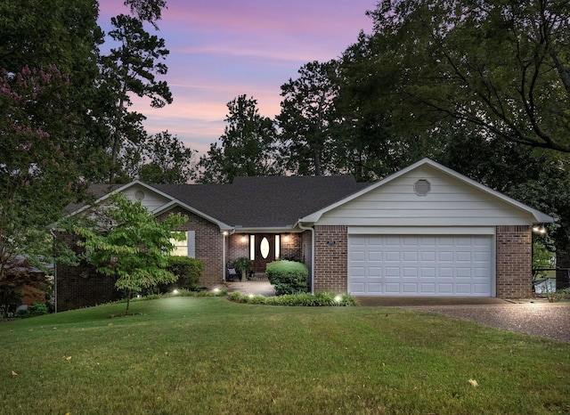 single story home with gravel driveway, a lawn, and brick siding