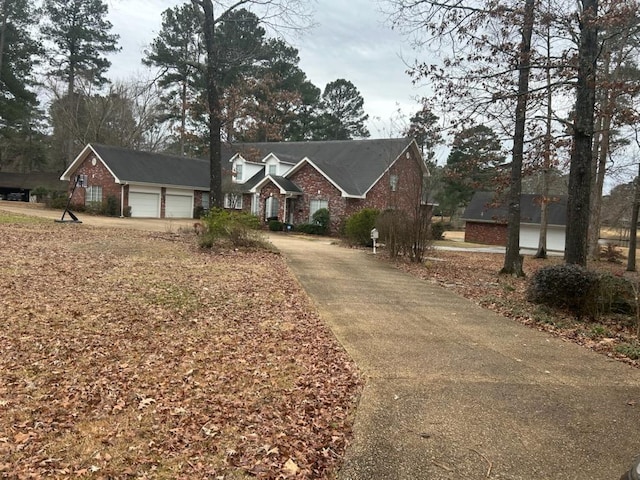 view of front facade with brick siding and a garage