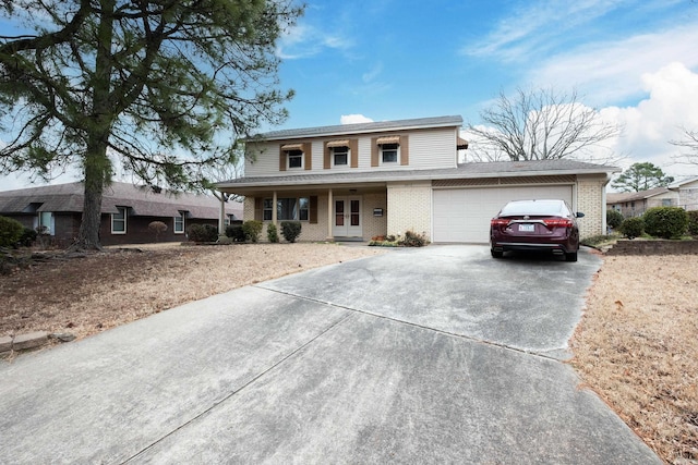 traditional-style house featuring concrete driveway, brick siding, an attached garage, and covered porch