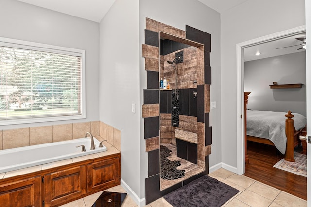 ensuite bathroom featuring ceiling fan, tile patterned flooring, connected bathroom, and a shower stall