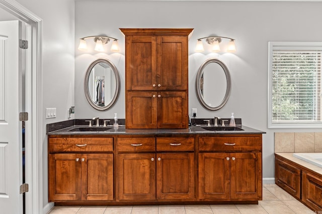 bathroom featuring double vanity, a sink, and tile patterned floors