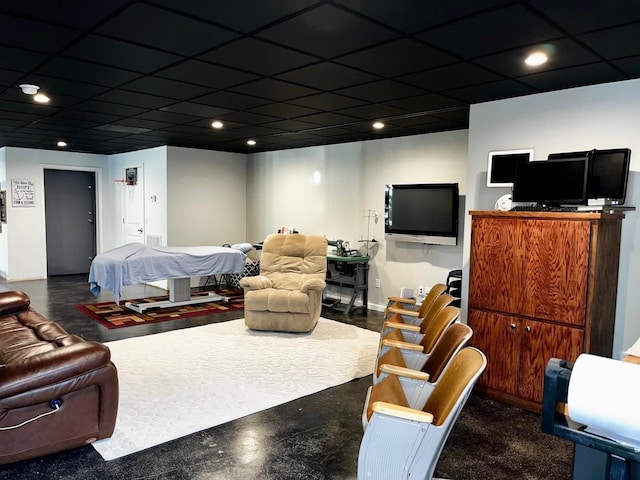 living area featuring baseboards, a drop ceiling, and recessed lighting