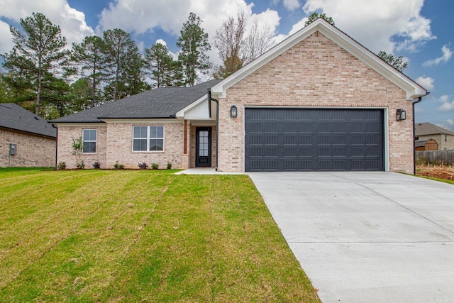 single story home with a garage, a front yard, brick siding, and driveway