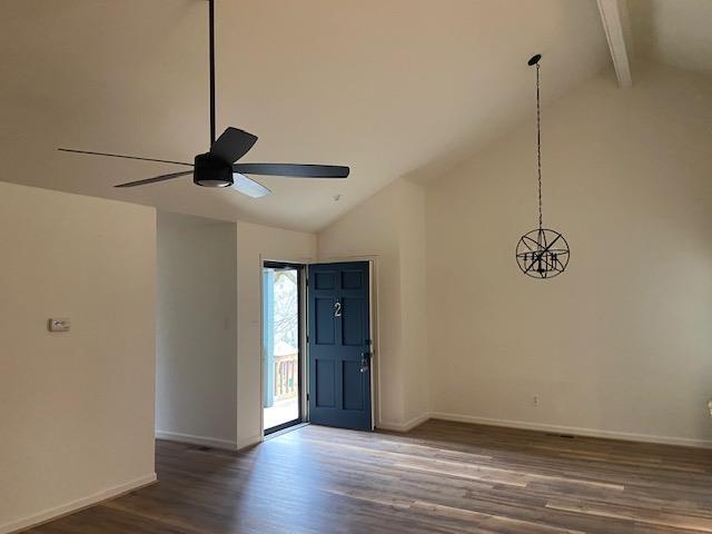 entryway featuring dark wood-type flooring, beam ceiling, and baseboards