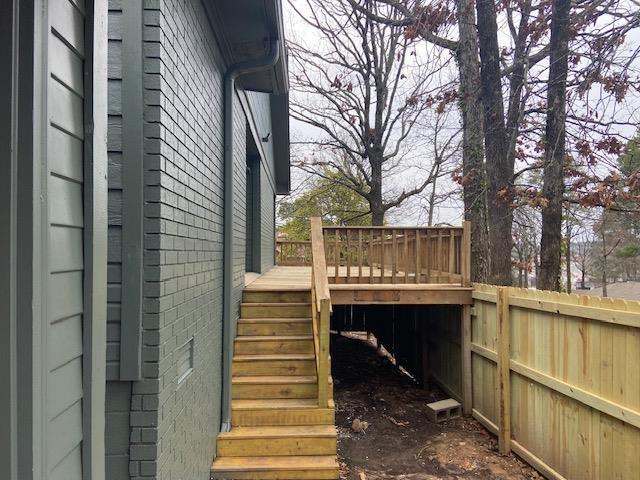 deck featuring stairs and fence