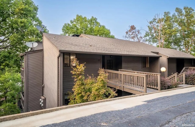 view of front of property featuring roof with shingles