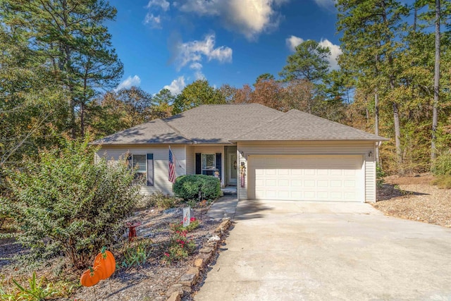 ranch-style home featuring a garage, roof with shingles, and driveway