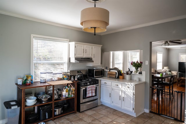 kitchen featuring under cabinet range hood, stainless steel appliances, white cabinetry, light countertops, and crown molding