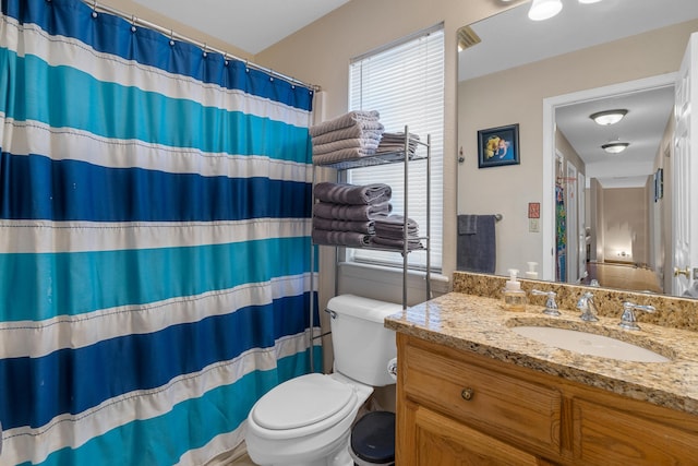 full bath featuring curtained shower, vanity, and toilet