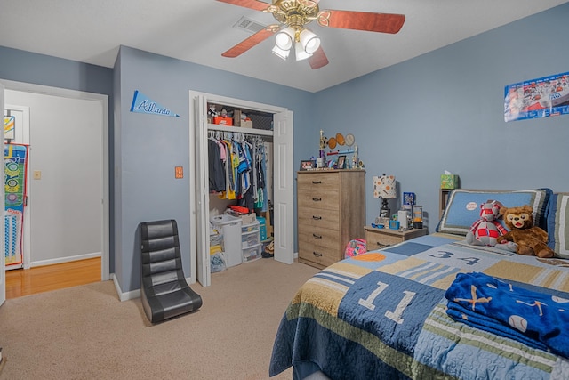 bedroom with ceiling fan, a closet, carpet flooring, and visible vents