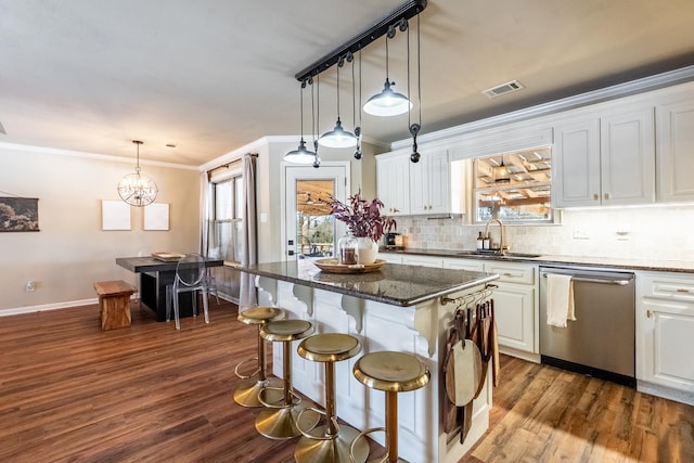 kitchen with visible vents, white cabinetry, a sink, dark stone counters, and dishwasher