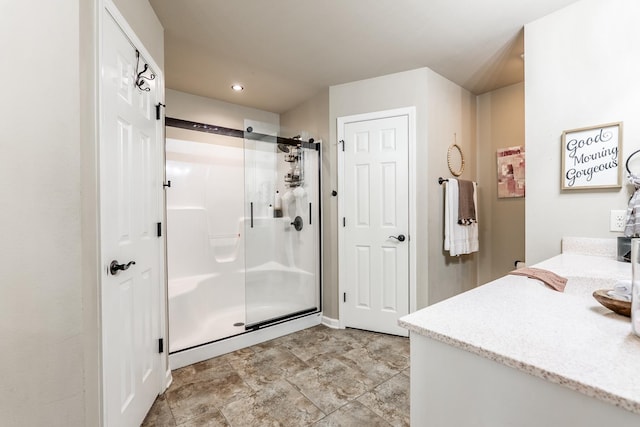 full bath with recessed lighting, a shower stall, and vanity