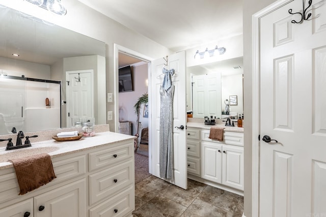 ensuite bathroom featuring a stall shower, connected bathroom, and vanity