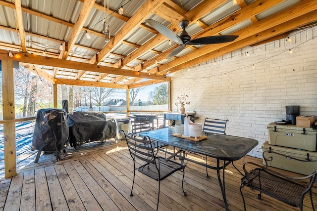 deck featuring grilling area, a ceiling fan, and outdoor dining space