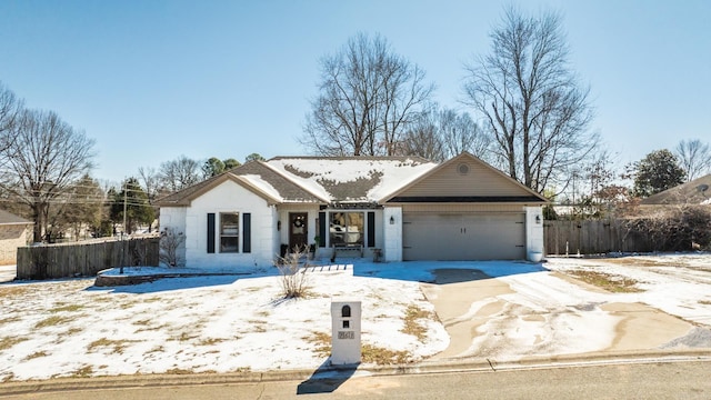 ranch-style home with a garage, fence, and concrete driveway