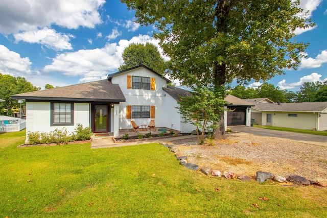 view of front of property with an attached garage, driveway, and a front lawn